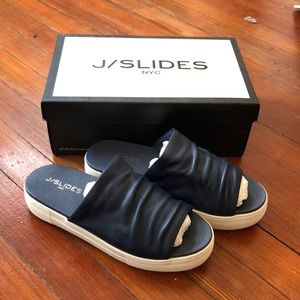 Women’s navy J slide Slip ons